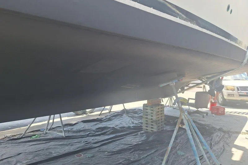 Slide: The Image of Bottom view of a 1988 Birchwood 44TS boat on stands, undergoing maintenance. - 45
