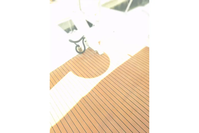 Slide: The Image of Overexposed image of a Birchwood 44TS yacht deck, showcasing wooden flooring, 1988 model. - 38
