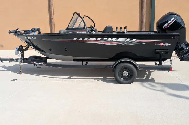 The Image of 2021 Tracker Pro Guide V-175 Combo boat on trailer, side view, black exterior. - 0
