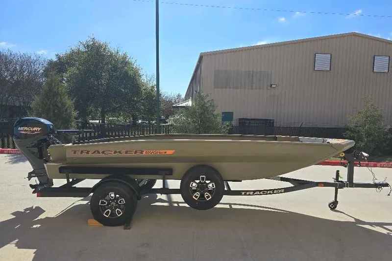 The Image of 2026 Tracker Grizzly 1756 T Marsh boat on trailer, outdoors in sunlight. - 0
