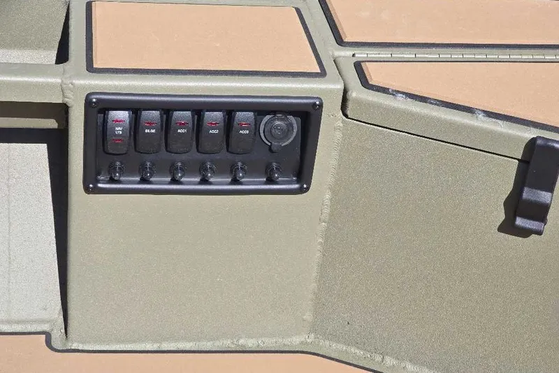 Slide: The Image of Control panel of 2026 Tracker Grizzly 1756 T Marsh boat with switches and outlets. - 14