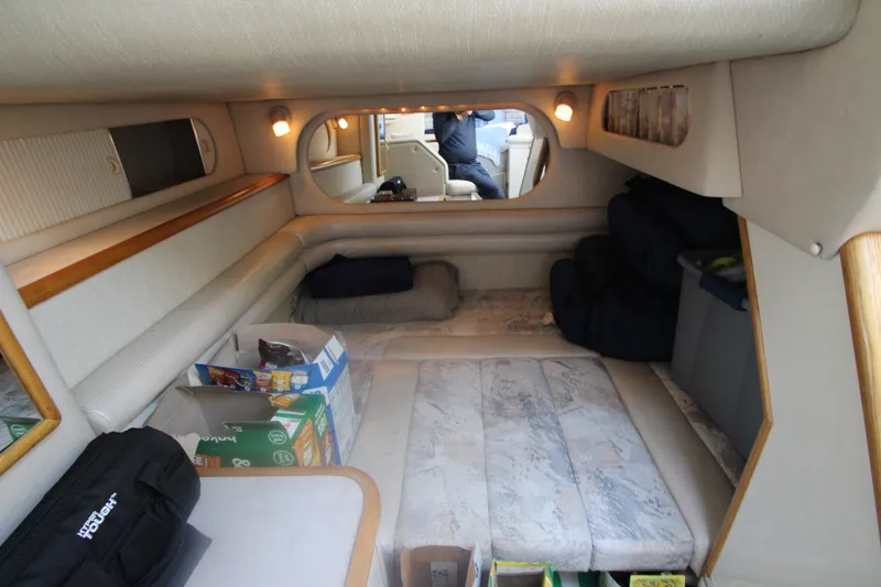 Slide: The Image of Interior cabin of a 1996 Sea Ray Sundancer 330 with cozy seating and storage. - 29