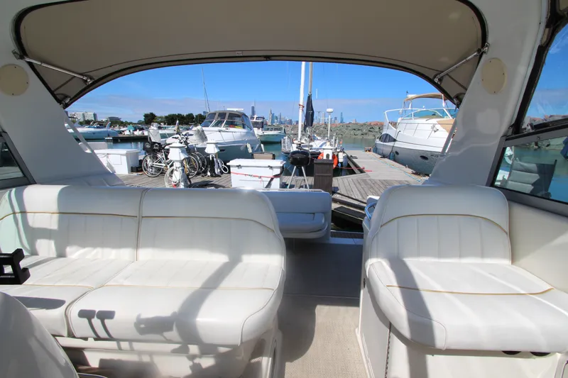 Slide: The Image of 1996 Sea Ray Sundancer 330 interior with white seating, docked at marina. - 19