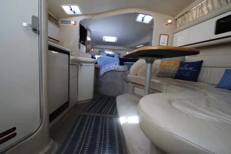 Slide: The Image of Interior of a 1996 Sea Ray Sundancer 330 yacht, featuring cozy seating and modern amenities. - 22
