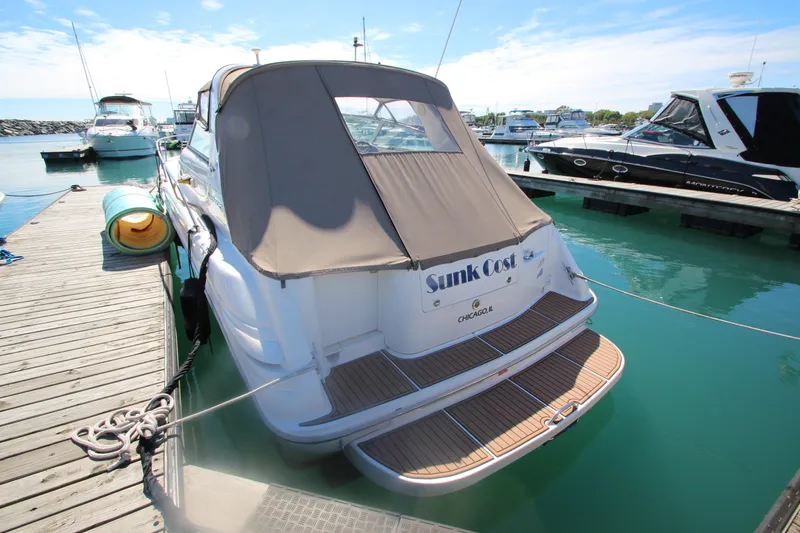 Slide: The Image of 1996 Sea Ray Sundancer 330 docked at marina, rear view with cover. - 3