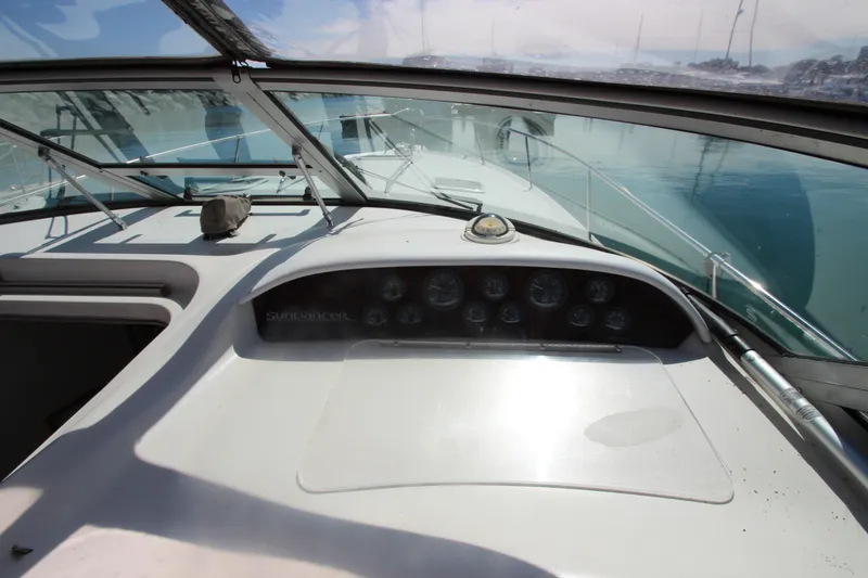 Slide: The Image of 1996 Sea Ray Sundancer 330 dashboard with gauges, overlooking calm waters. - 18