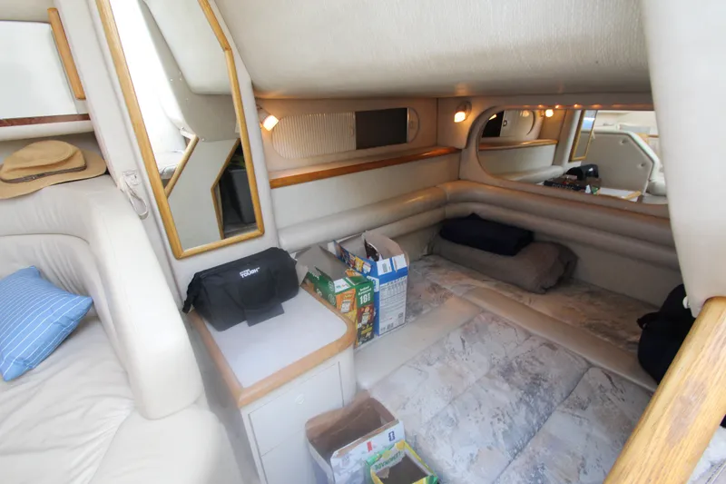 Slide: The Image of Interior of a 1996 Sea Ray Sundancer 330 yacht, featuring cozy seating and storage. - 30