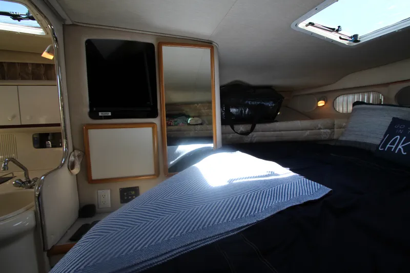 Slide: The Image of Interior cabin of 1996 Sea Ray Sundancer 330 with bed, TV, and skylight. - 25