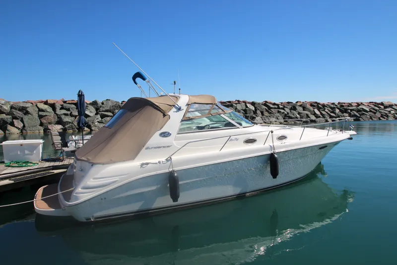 Slide: The Image of 1996 Sea Ray Sundancer 330 yacht docked in calm waters, clear blue sky. - 1