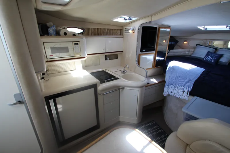Slide: The Image of Interior of 1996 Sea Ray Sundancer 330 yacht with kitchenette and cozy sleeping area. - 23