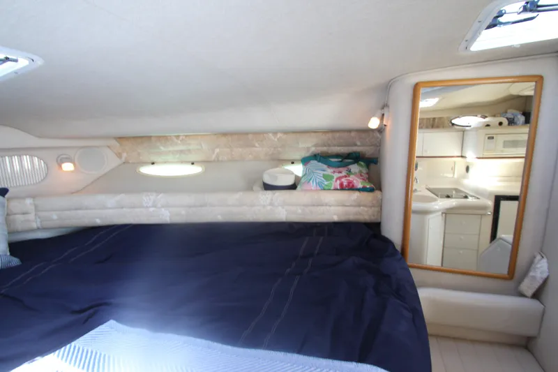 Slide: The Image of Interior cabin of 1996 Sea Ray Sundancer 330 with bed and kitchenette. - 26