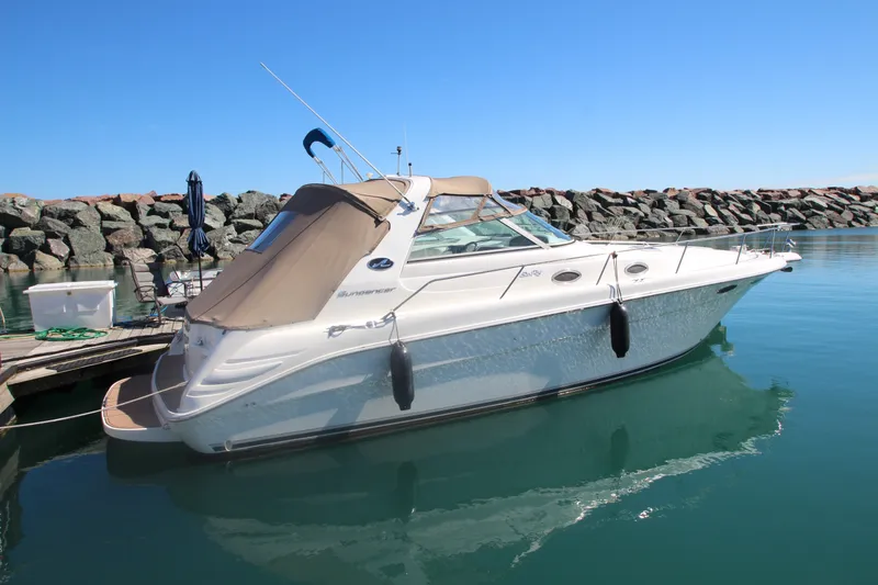 The Image of 1996 Sea Ray Sundancer 330 yacht docked in calm marina waters. - 0