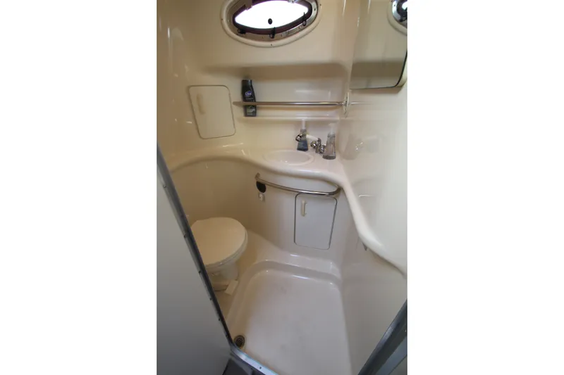 Slide: The Image of Compact bathroom in 1996 Sea Ray Sundancer 330 yacht with sink, toilet, and storage. - 32