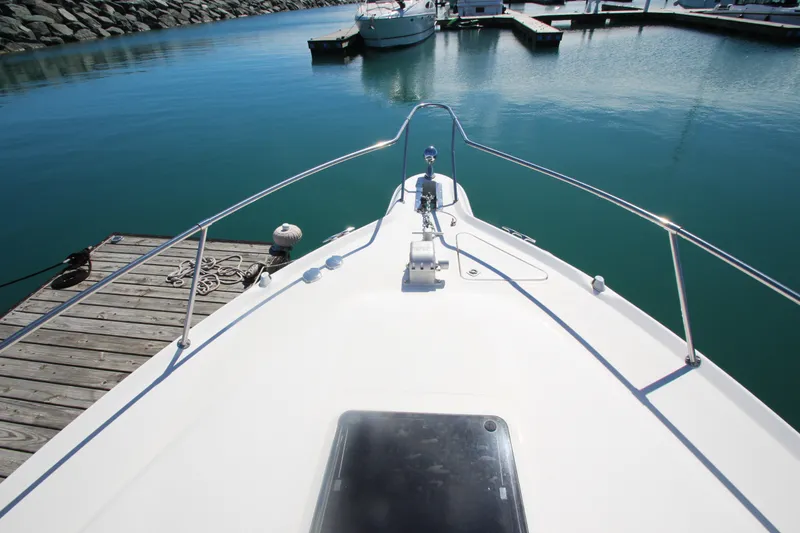 Slide: The Image of Bow view of 1996 Sea Ray Sundancer 330 docked in a marina. - 8