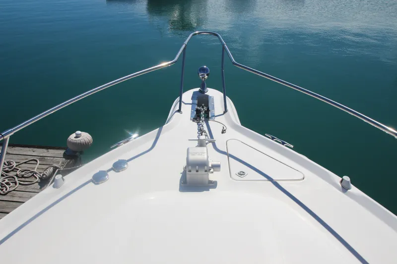 Slide: The Image of Bow view of 1996 Sea Ray Sundancer 330 yacht docked on calm water. - 9