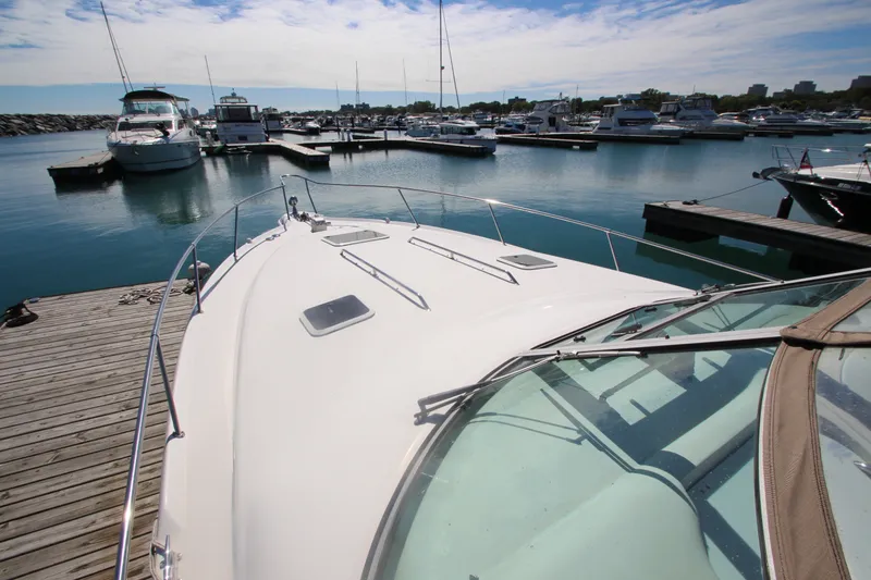 Slide: The Image of 1996 Sea Ray Sundancer 330 docked at a marina under a clear blue sky. - 7