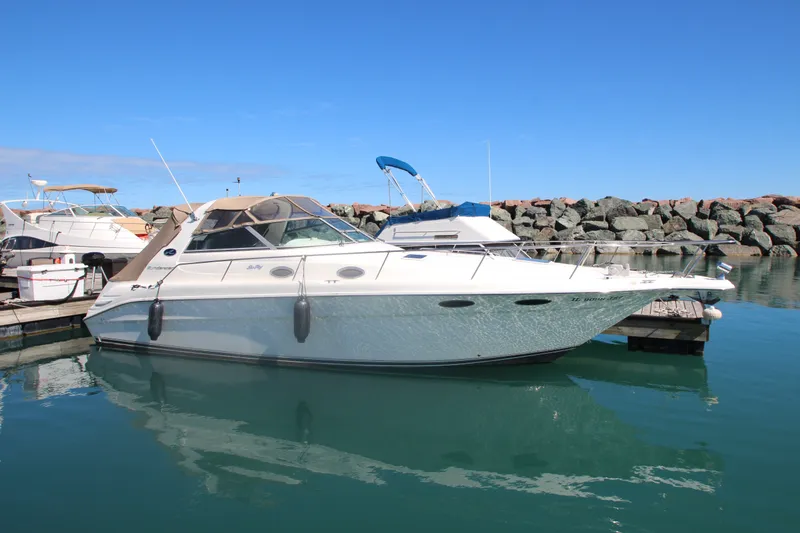 Slide: The Image of 1996 Sea Ray Sundancer 330 yacht docked in a marina with clear blue skies. - 2
