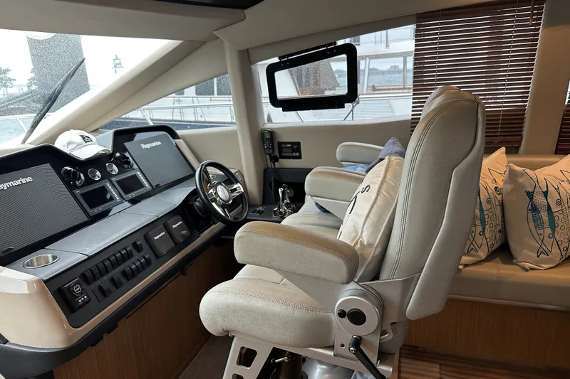 Slide: The Image of Luxurious 2018 Sea Ray L590 yacht helm with plush seating and advanced navigation systems. - 9