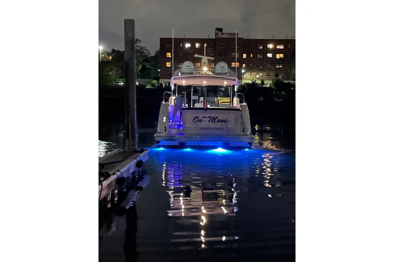 Slide: The Image of 2018 Sea Ray L590 yacht docked at night with blue underwater lights. - 5