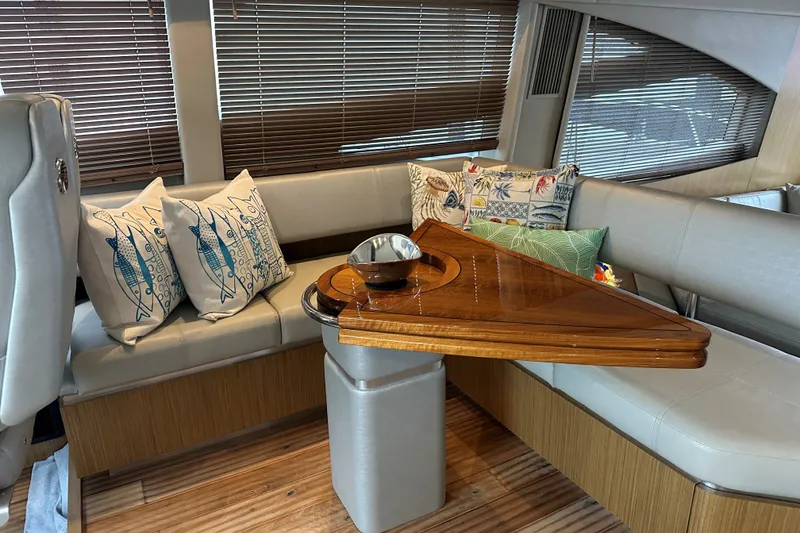 Slide: The Image of Luxurious 2018 Sea Ray L590 yacht interior with elegant seating and decorative pillows. - 12