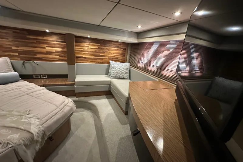Slide: The Image of Luxurious interior of 2018 Sea Ray L590 yacht with modern wood accents and cozy seating. - 14