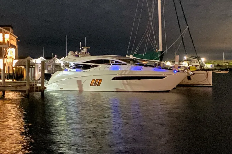 Slide: The Image of 2018 Sea Ray L590 yacht docked at night, illuminated with blue lights. - 4