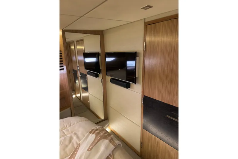 Slide: The Image of Luxurious interior of 2018 Sea Ray L590 yacht with modern TV and wood paneling. - 16