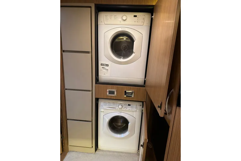 Slide: The Image of Stacked washer and dryer in 2018 Sea Ray L590 yacht's wooden cabinet. - 20