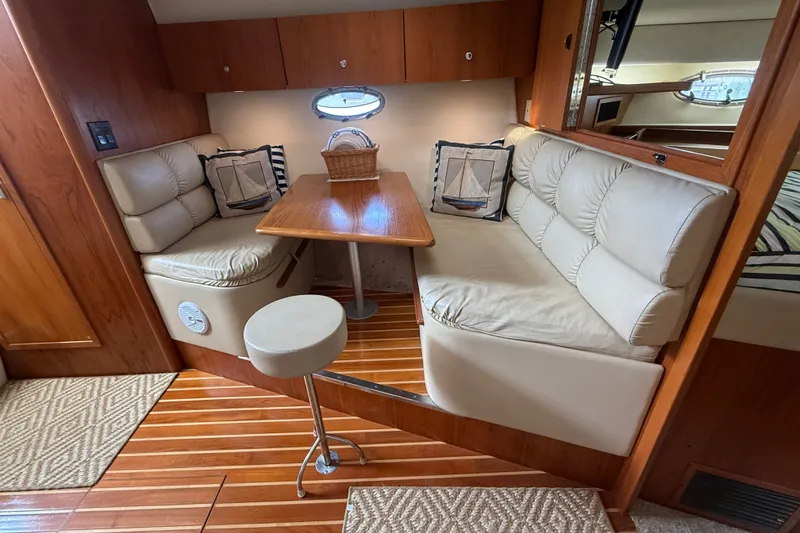 Slide: The Image of Interior of 1997 Tiara 3500 EXPRESS yacht with cozy seating and wooden table. - 17