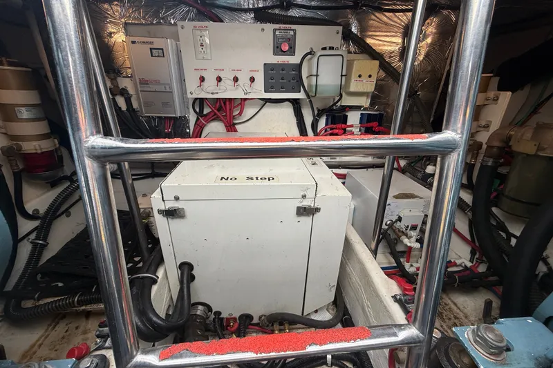 Slide: The Image of Engine room of a 1997 Tiara 3500 EXPRESS boat, featuring electrical components and wiring. - 26