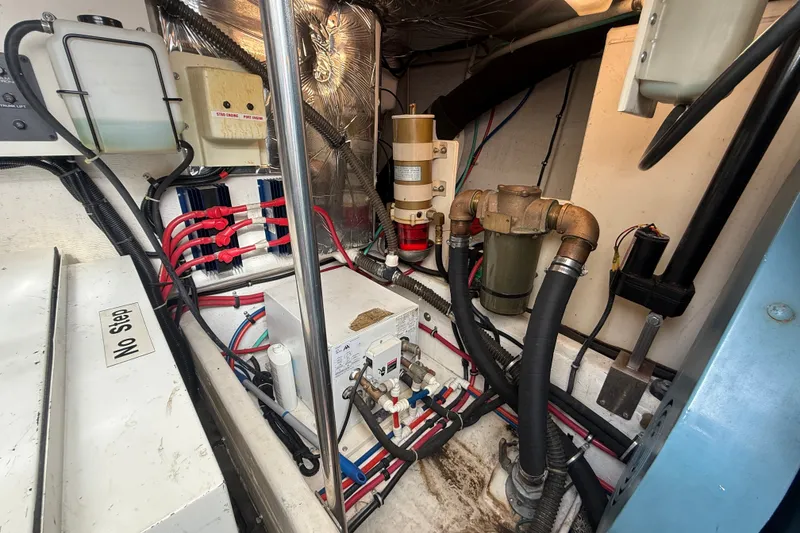 Slide: The Image of Engine room of a 1997 Tiara 3500 EXPRESS boat, showcasing mechanical components and wiring. - 27