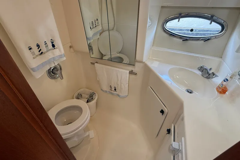 Slide: The Image of Compact bathroom in 1997 Tiara 3500 EXPRESS yacht with nautical-themed decor. - 22