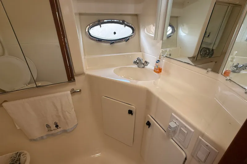 Slide: The Image of Bathroom interior of 1997 Tiara 3500 EXPRESS yacht, featuring sink and mirror. - 23