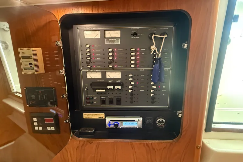 Slide: The Image of Electrical control panel inside a 1997 Tiara 3500 EXPRESS boat cabin. - 24