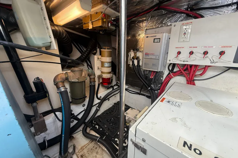 Slide: The Image of Engine room of a 1997 Tiara 3500 EXPRESS boat with electrical panels and wiring. - 28