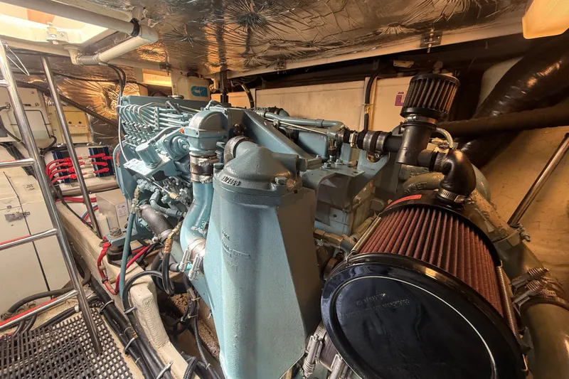 Slide: The Image of Engine room of a 1997 Tiara 3500 EXPRESS boat, showcasing detailed machinery. - 31