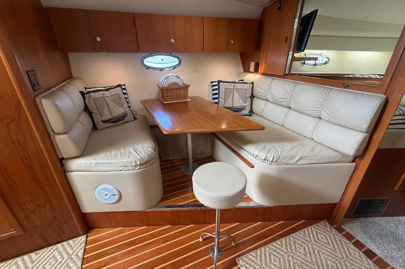 Slide: The Image of Interior of 1997 Tiara 3500 EXPRESS yacht with cozy seating and wooden table. - 16