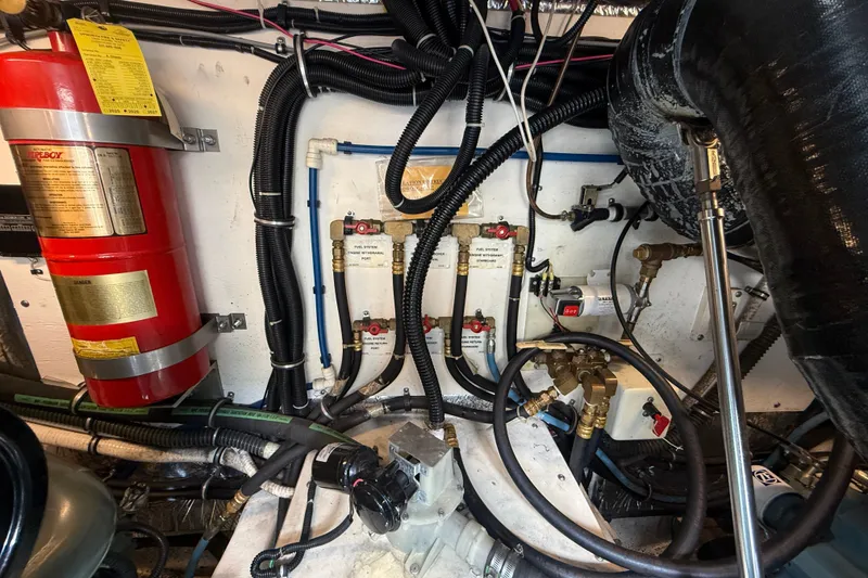 Slide: The Image of Engine room of a 1997 Tiara 3500 EXPRESS with fire extinguisher and fuel system components. - 29