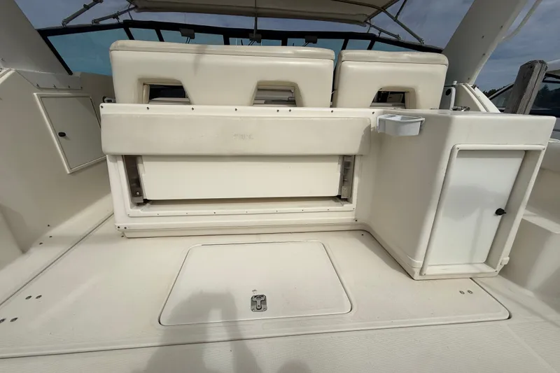 Slide: The Image of 1997 Tiara 3500 EXPRESS boat interior with seating and storage compartments. - 25