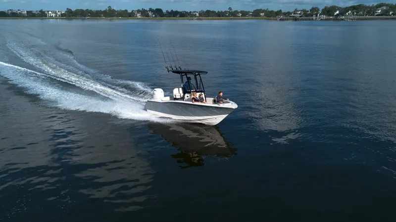 Slide: The Image of Scout 200 Sportfish 2027 on calm water with passengers on board. - 11