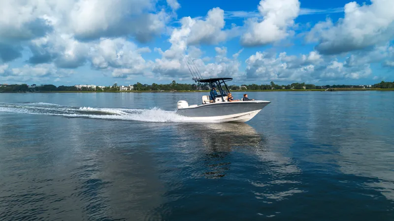 Slide: The Image of A Scout 200 Sportfish boat speeds across calm water under a cloudy sky. - 10