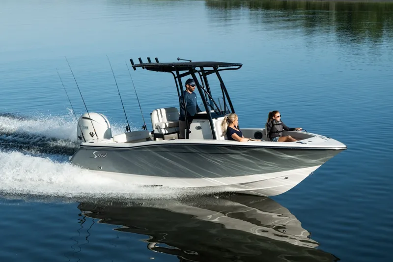Slide: The Image of Scout 200 Sportfish 2027 on calm water with three people on board. - 3