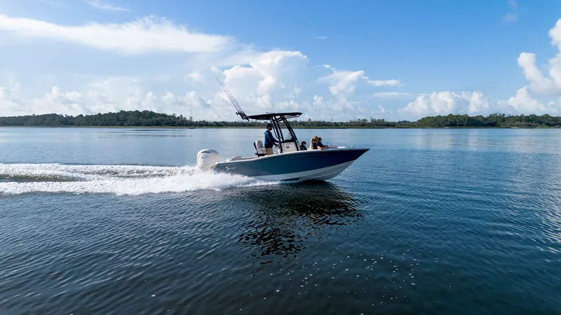 Slide: The Image of Scout 200 Sportfish 2027 on calm water with blue sky and clouds. - 9