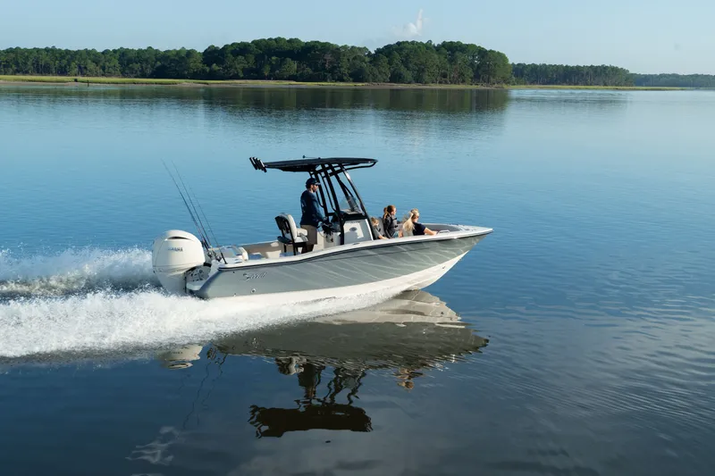 Slide: The Image of A 2027 Scout 200 Sportfish boat speeds across calm water. - 6