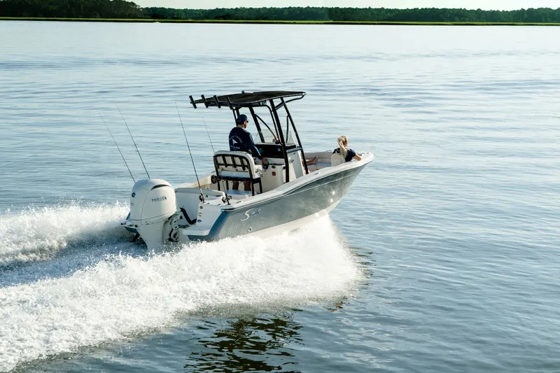 Slide: The Image of Scout 200 Sportfish 2027 on calm water with two people on board. - 1