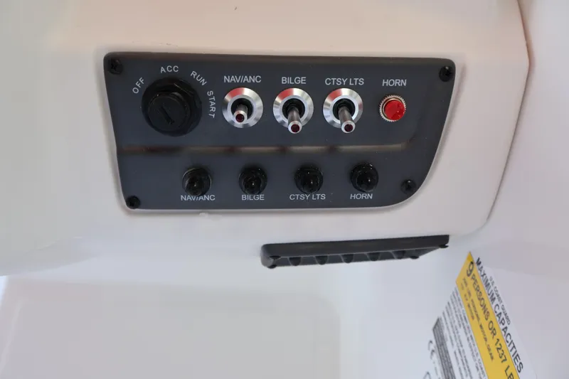 Slide: The Image of Control panel of 2027 Tahoe T18 boat with switches and labels. - 18