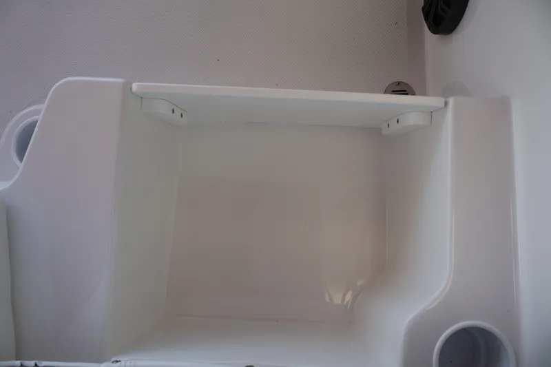 Slide: The Image of Storage compartment in 2027 Tahoe T18 boat, featuring a sleek white interior design. - 25