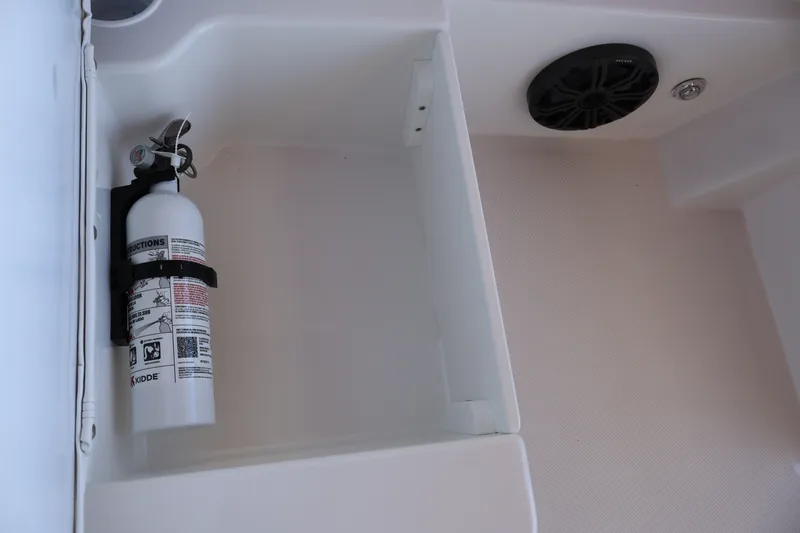 Slide: The Image of Fire extinguisher and speaker in 2027 Tahoe T18 boat compartment. - 26