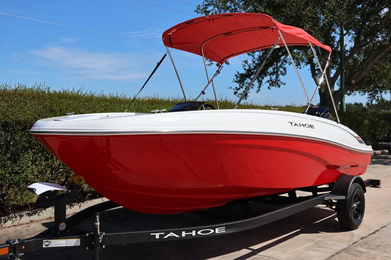 Slide: The Image of 2027 Tahoe T18 boat with red hull and canopy on trailer. - 2