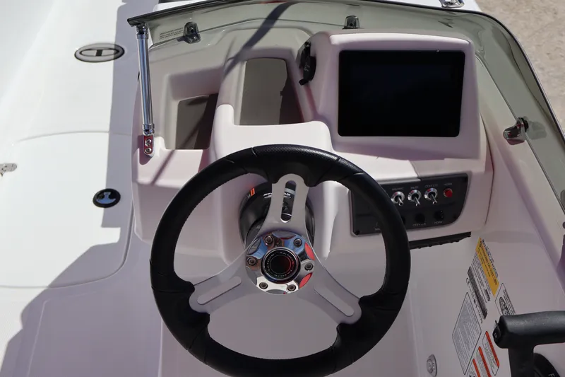 Slide: The Image of Steering console of a 2027 Tahoe T18 boat with modern controls and display. - 15